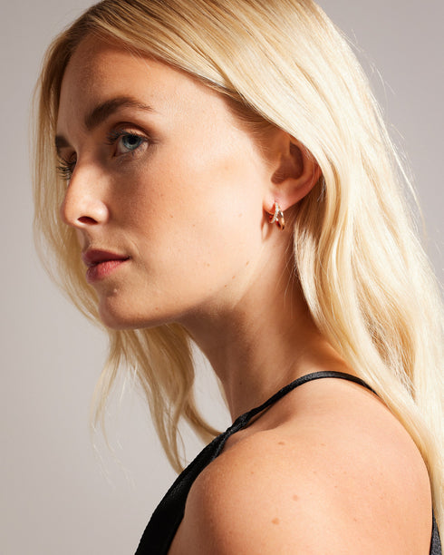 HELIAS-Jewellery-Need A New Go-to Piece? Meet Helias Our Dazzling Double Huggie Hoop Earrings. These Statement Earrings Feature A Striking Contrasting Texture With One Hoop Adorned With Shimmering Crystals For An Extra Touch Of Glamour. Double huggie hoop earrings Contrasting texture One crystal embellished hoop Engraved logo Stud back Comes in Ted Baker branded gift box- Ted Baker Romania